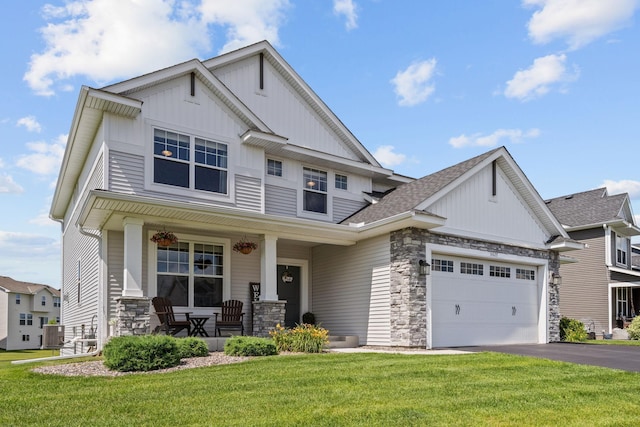 5027 Jansen Ave NE, Saint Michael, MN 55376 - craftsman-style house featuring stone siding, a porch, board and batten siding, and a garage