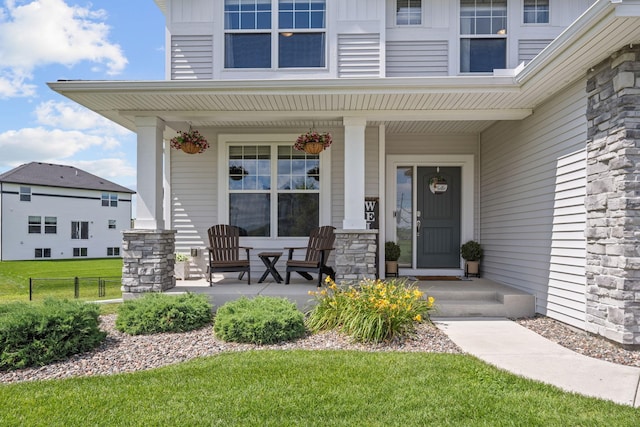 5027 Jansen Ave NE, Saint Michael, MN 55376 - doorway to property featuring a porch, stone siding, and a lawn