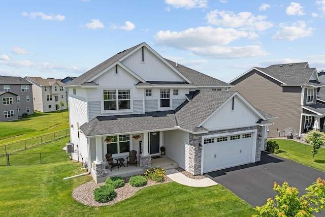 5027 Jansen Ave NE, Saint Michael, MN 55376 - view of front of property with board and batten siding, a shingled roof, driveway, covered porch, and a garage