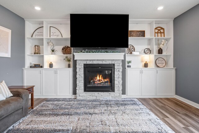 5027 Jansen Ave NE, Saint Michael, MN 55376 - living room with wood finished floors, built in features, and a fireplace