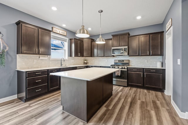 5027 Jansen Ave NE, Saint Michael, MN 55376 - kitchen featuring stainless steel appliances, dark brown cabinets, light wood-type flooring, and recessed lighting