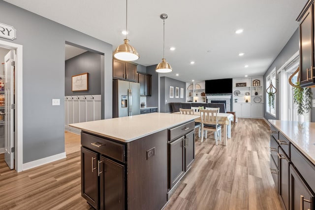 5027 Jansen Ave NE, Saint Michael, MN 55376 - kitchen with stainless steel fridge, light wood-style floors, light countertops, dark brown cabinetry, and recessed lighting
