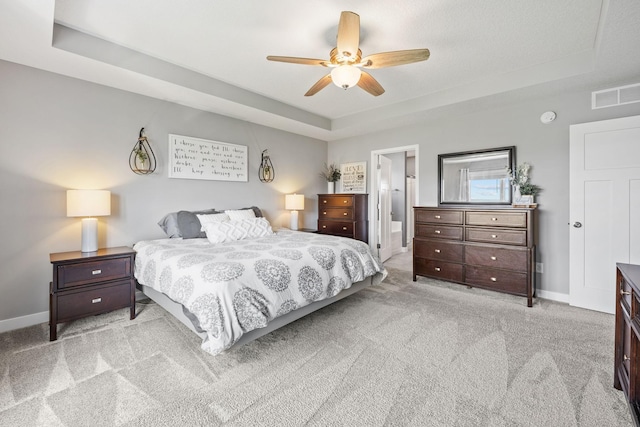 5027 Jansen Ave NE, Saint Michael, MN 55376 - bedroom featuring a tray ceiling, light colored carpet, ensuite bathroom, and ceiling fan