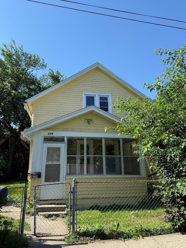 324 Van Buren Ave, Saint Paul, MN 55103 - bungalow-style home with a gate, a fenced front yard, and a sunroom