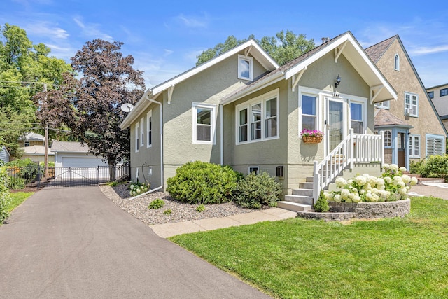 500 Otis Ave, Saint Paul, MN 55104 - bungalow-style house featuring a garage and stucco siding