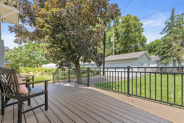500 Otis Ave, Saint Paul, MN 55104 - wooden deck featuring a lawn, an outdoor structure, and a detached garage