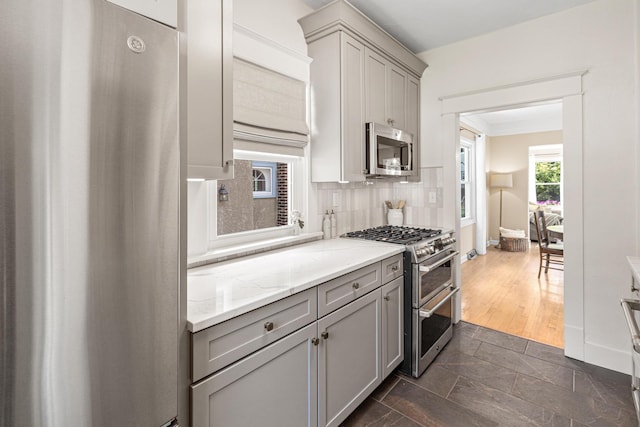 500 Otis Ave, Saint Paul, MN 55104 - kitchen with appliances with stainless steel finishes, gray cabinets, and backsplash