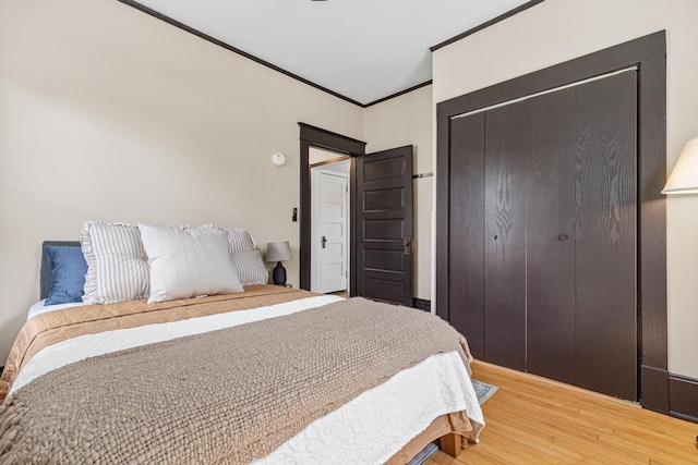 500 Otis Ave, Saint Paul, MN 55104 - bedroom featuring light wood-style floors, a closet, and ornamental molding