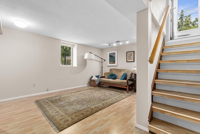 500 Otis Ave, Saint Paul, MN 55104 - basement featuring stairs, wood finished floors, and rail lighting