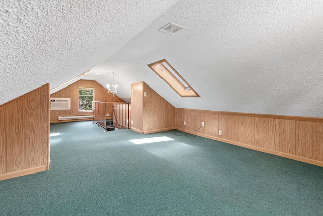 500 Otis Ave, Saint Paul, MN 55104 - bonus room with baseboard heating, wood walls, a textured ceiling, vaulted ceiling, and carpet flooring