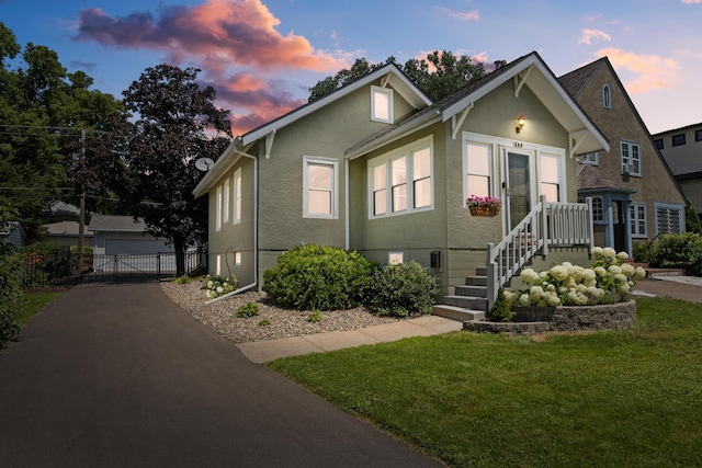 500 Otis Ave, Saint Paul, MN 55104 - bungalow-style house with stucco siding, a garage, and an outbuilding