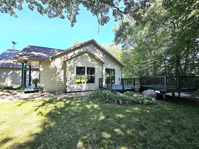 21578 Edwards Dr, Irondale Twp, MN 56455 - rear view of property with a yard, a wooden deck, and a shingled roof
