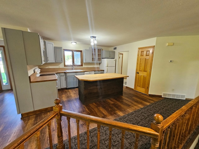 21578 Edwards Dr, Irondale Twp, MN 56455 - kitchen featuring white appliances, gray cabinets, butcher block counters, dark wood finished floors, and a textured ceiling