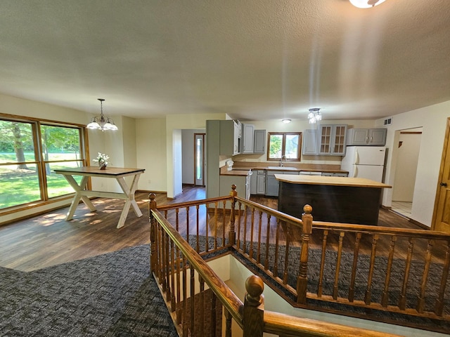 21578 Edwards Dr, Irondale Twp, MN 56455 - kitchen with gray cabinetry, freestanding refrigerator, dark wood-type flooring, and a center island