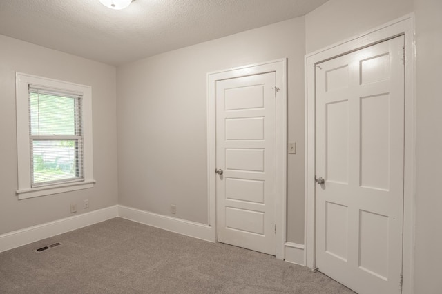 3919 Dupont Ave N, Minneapolis, MN 55412 - unfurnished bedroom with carpet flooring and a textured ceiling