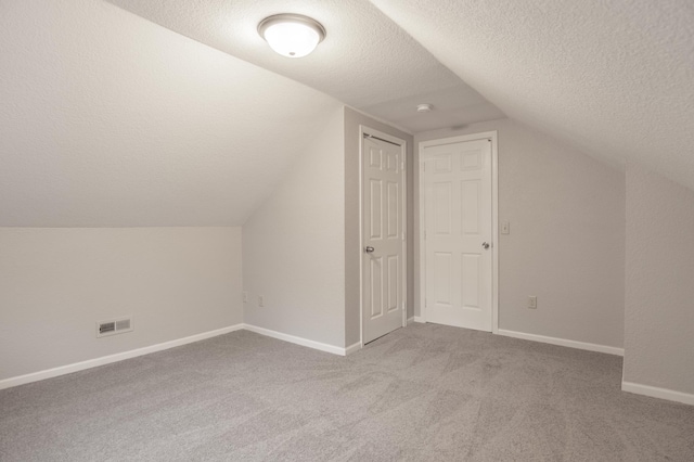 3919 Dupont Ave N, Minneapolis, MN 55412 - bonus room featuring a textured ceiling, vaulted ceiling, and carpet