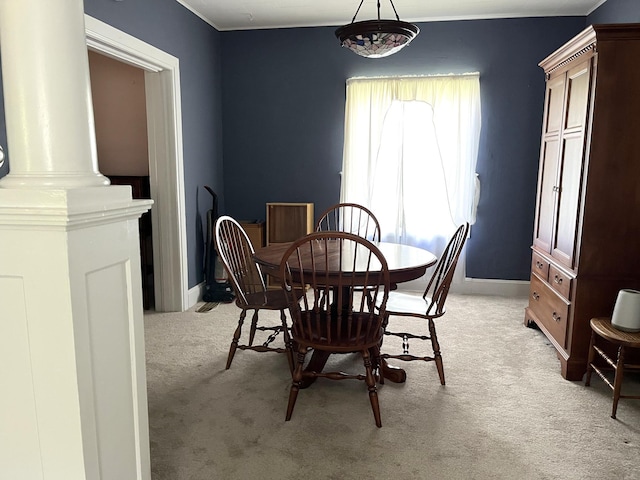 1157 6th Ave S, Windom, MN 56101 - dining space featuring light colored carpet and decorative columns