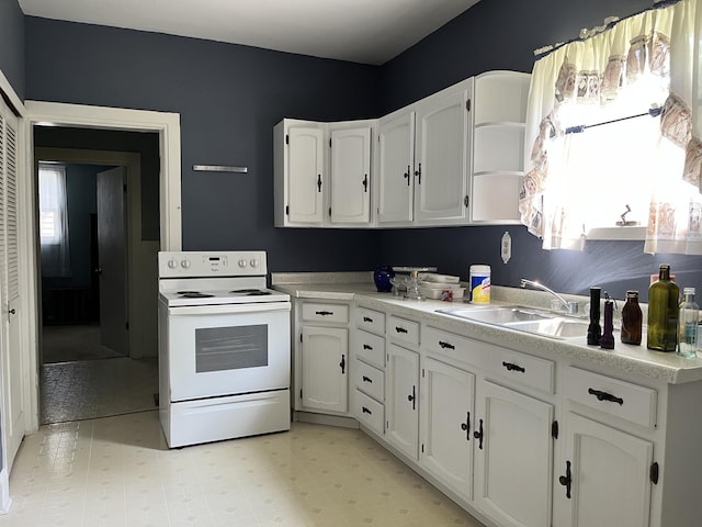 1157 6th Ave S, Windom, MN 56101 - kitchen featuring white electric stove, open shelves, white cabinetry, light countertops, and light flooring