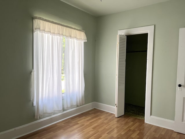 1157 6th Ave S, Windom, MN 56101 - unfurnished bedroom featuring wood finished floors and a closet