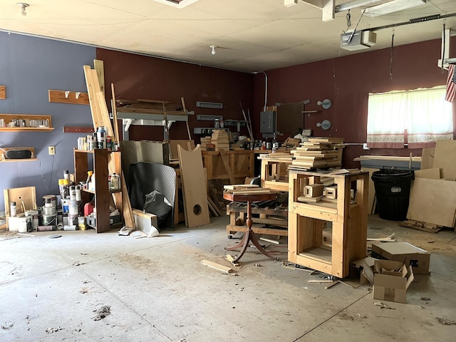 1157 6th Ave S, Windom, MN 56101 - garage featuring a garage door opener, electric panel, and a workshop area