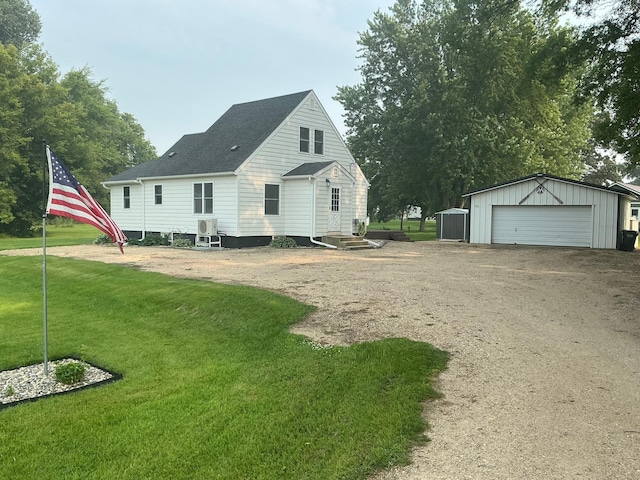 705 State Highway 28 W, Glenwood, MN 56334 - back of property with an outbuilding, a yard, a detached garage, and roof with shingles