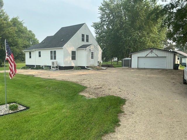 705 State Highway 28 W, Glenwood, MN 56334 - back of property with an outdoor structure, a yard, a detached garage, dirt driveway, and a shingled roof