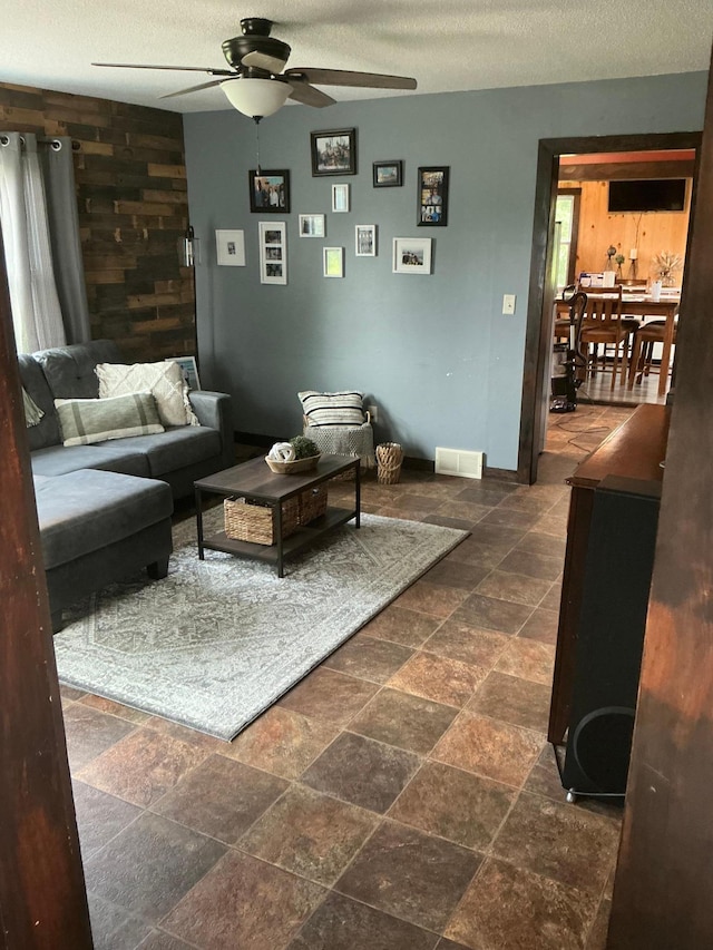 705 State Highway 28 W, Glenwood, MN 56334 - living area with ceiling fan, stone tile floors, and a textured ceiling