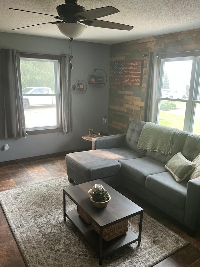 705 State Highway 28 W, Glenwood, MN 56334 - living room featuring a ceiling fan, a textured ceiling, and stone finish floors