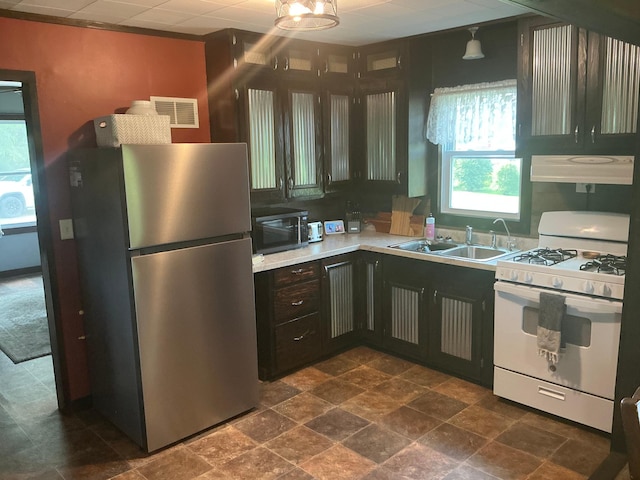 705 State Highway 28 W, Glenwood, MN 56334 - kitchen with appliances with stainless steel finishes, extractor fan, light countertops, and dark stone finish flooring