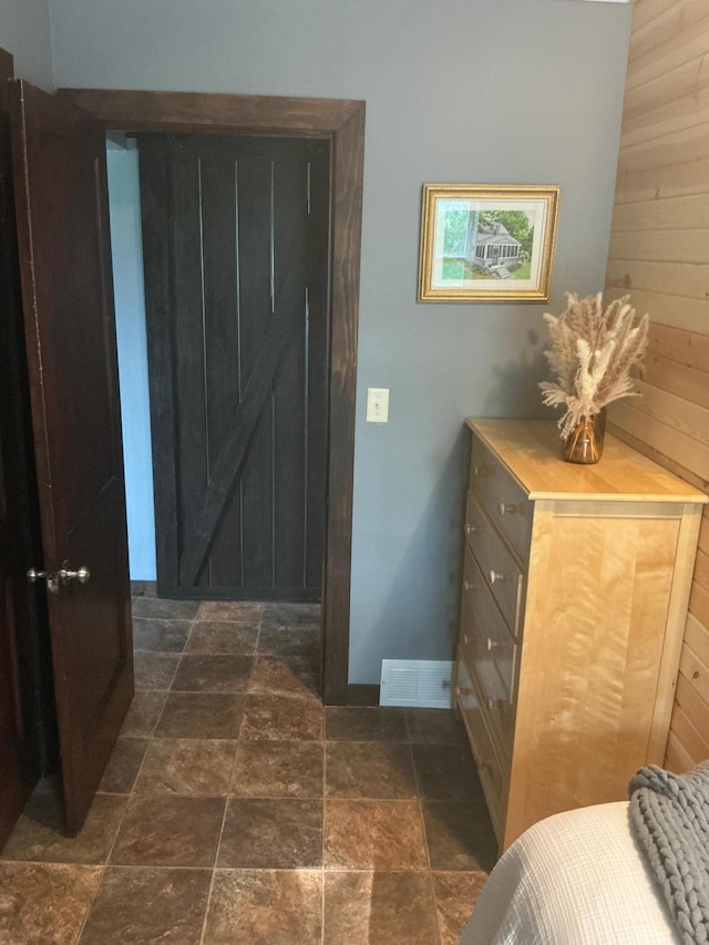705 State Highway 28 W, Glenwood, MN 56334 - bedroom with stone tile floors and wooden walls