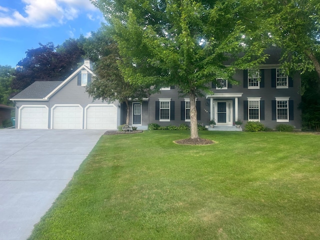 420 127th Ln NW, Coon Rapids, MN 55448 - colonial home with a garage, driveway, a front yard, and a chimney
