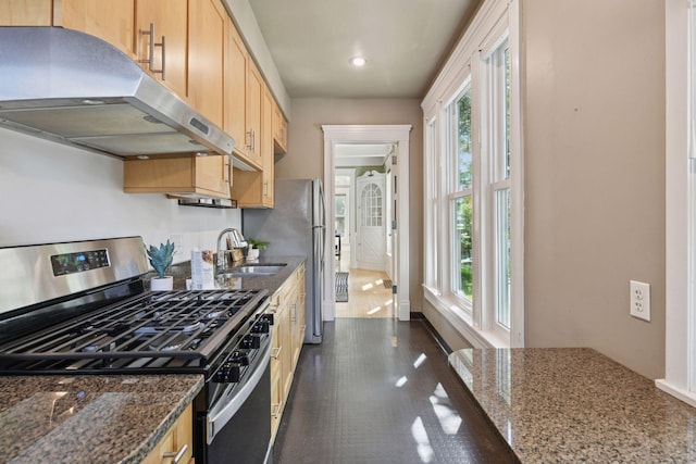 2432 Pleasant Ave, Minneapolis, MN 55404 - kitchen with stainless steel appliances, under cabinet range hood, dark stone countertops, light brown cabinetry, and recessed lighting