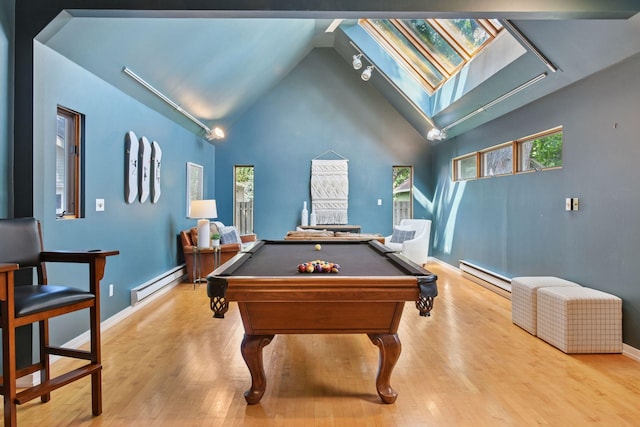 2432 Pleasant Ave, Minneapolis, MN 55404 - rec room featuring a baseboard heating unit, a skylight, a baseboard radiator, wood finished floors, and high vaulted ceiling