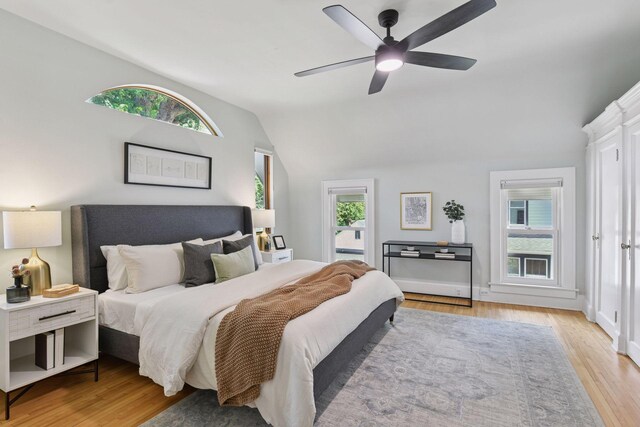 2432 Pleasant Ave, Minneapolis, MN 55404 - bedroom featuring vaulted ceiling, light wood-style flooring, multiple windows, and a ceiling fan