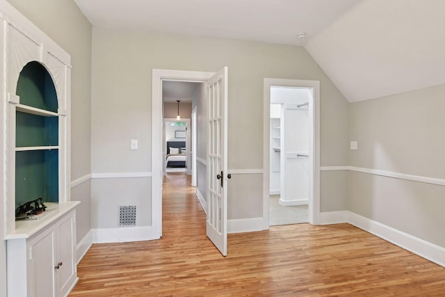 2432 Pleasant Ave, Minneapolis, MN 55404 - corridor with light wood-type flooring, french doors, and vaulted ceiling