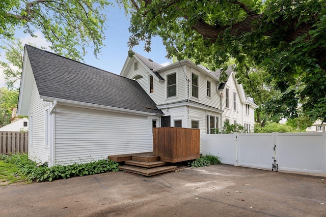 2432 Pleasant Ave, Minneapolis, MN 55404 - view of front of home with roof with shingles, a deck, and a gate