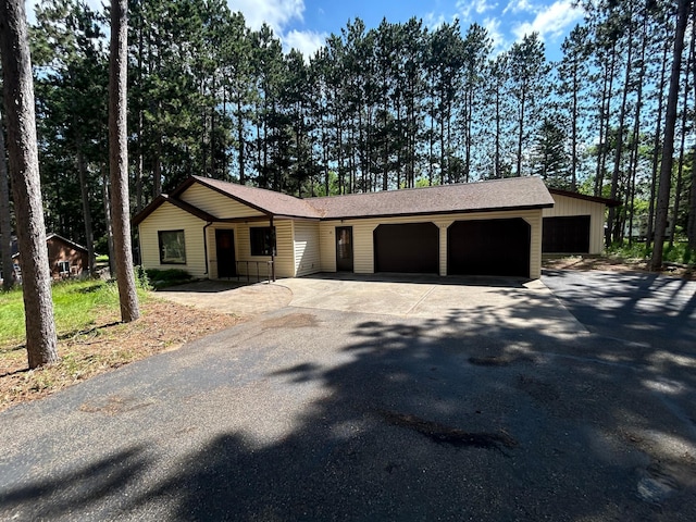353 River Dr, Park Rapids, MN 56470 - view of front of house featuring asphalt driveway, an attached garage, and roof with shingles