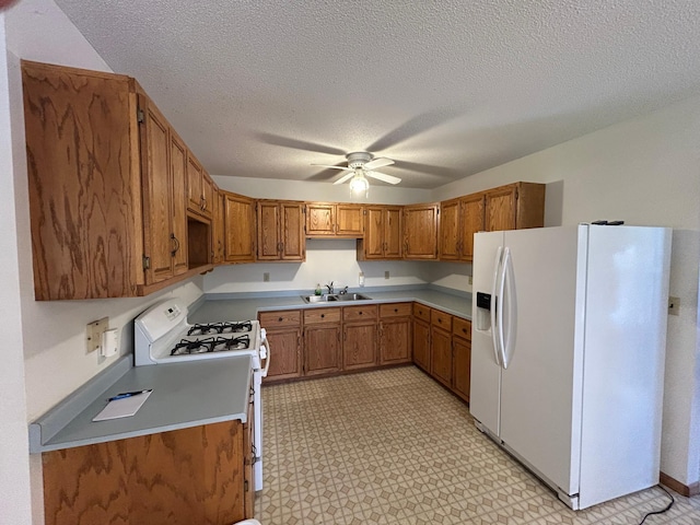 353 River Dr, Park Rapids, MN 56470 - kitchen with white appliances, brown cabinets, a ceiling fan, a textured ceiling, and light countertops