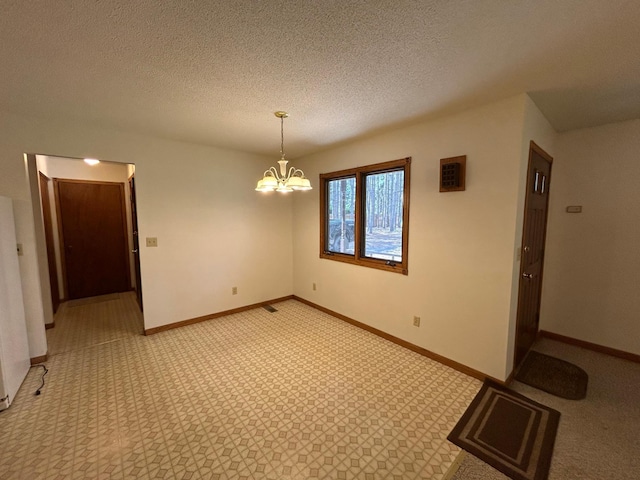 353 River Dr, Park Rapids, MN 56470 - spare room featuring a chandelier, a textured ceiling, and light colored carpet