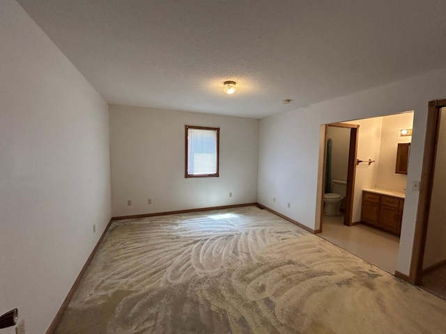 353 River Dr, Park Rapids, MN 56470 - unfurnished bedroom featuring light colored carpet and ensuite bathroom