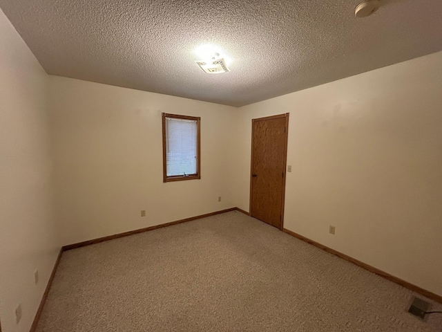 353 River Dr, Park Rapids, MN 56470 - empty room featuring light colored carpet, a textured ceiling, and a smoke detector
