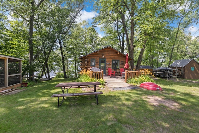29351 410th Pl, Farm Island Twp, MN 56431 - view of green lawn with a deck and an outdoor structure