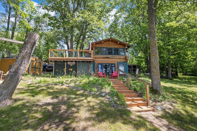 29351 410th Pl, Farm Island Twp, MN 56431 - back of property with a wooden deck, stairway, and a lawn