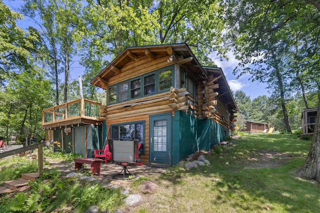 29351 410th Pl, Farm Island Twp, MN 56431 - rear view of house featuring log exterior, a yard, and a wooden deck
