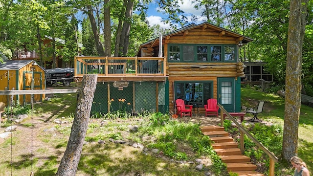 29351 410th Pl, Farm Island Twp, MN 56431 - rear view of property with a deck, stairs, log exterior, and an outbuilding