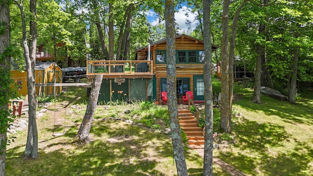 29351 410th Pl, Farm Island Twp, MN 56431 - view of play area featuring stairway, a wooden deck, an outbuilding, and a yard