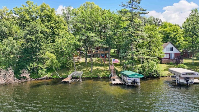 29351 410th Pl, Farm Island Twp, MN 56431 - dock area featuring boat lift, view of wooded area, and a deck with water view