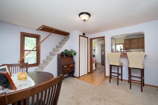 18726 Juneberry Rd, Mankato, MN 56001 - dining room with arched walkways, light colored carpet, healthy amount of natural light, and stairs