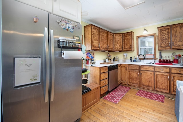 18726 Juneberry Rd, Mankato, MN 56001 - kitchen featuring appliances with stainless steel finishes, ornamental molding, light countertops, light wood finished floors, and brown cabinetry