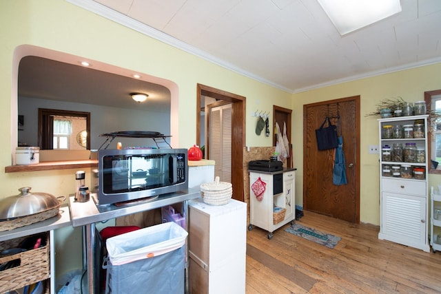 18726 Juneberry Rd, Mankato, MN 56001 - kitchen featuring stainless steel microwave, wood finished floors, crown molding, and arched walkways
